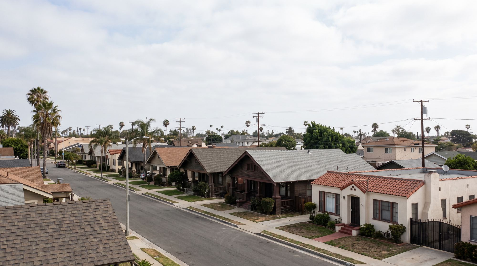A flat Long Beach street of Craftsman bungalows and small Spanish houses