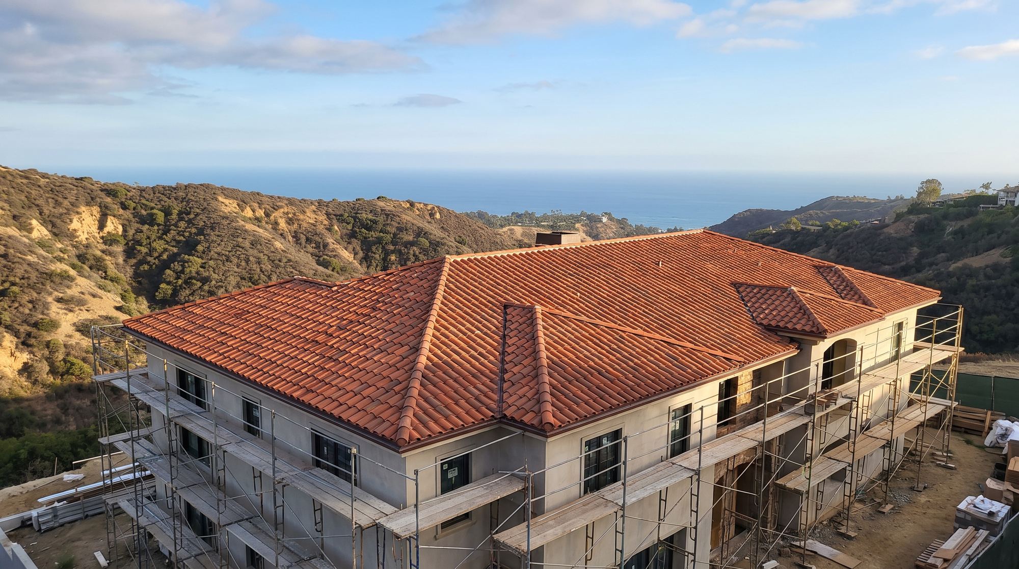 A rebuilt Pacific Palisades house with a new fire-resistant tile roof