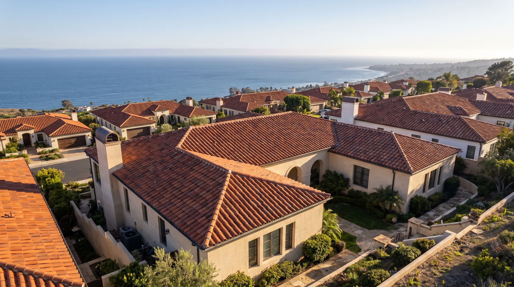 Mediterranean houses with red clay barrel tile roofs above the coast in Palos Verdes Estates