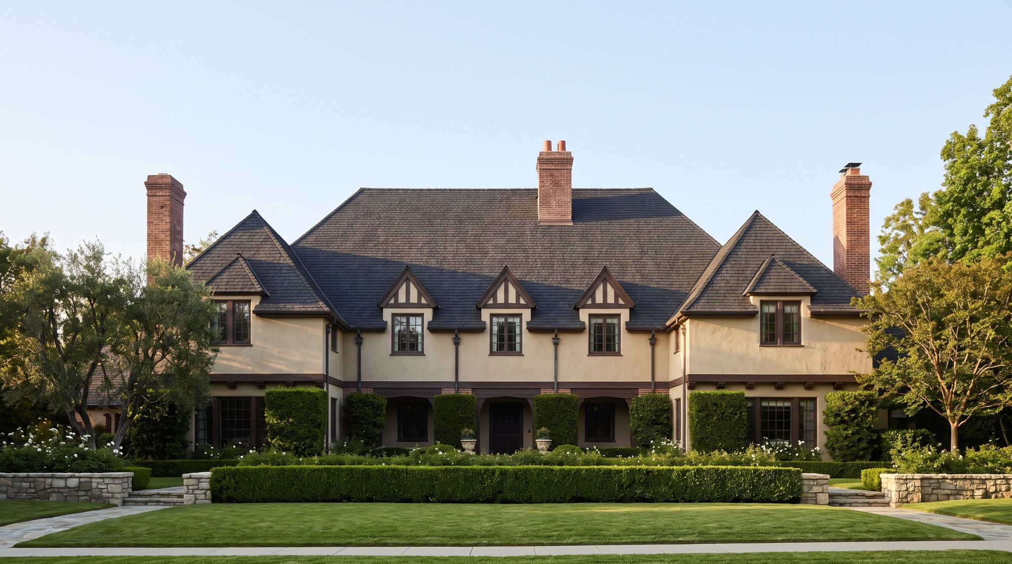A large traditional San Marino house with a steep shingle roof and brick chimneys
