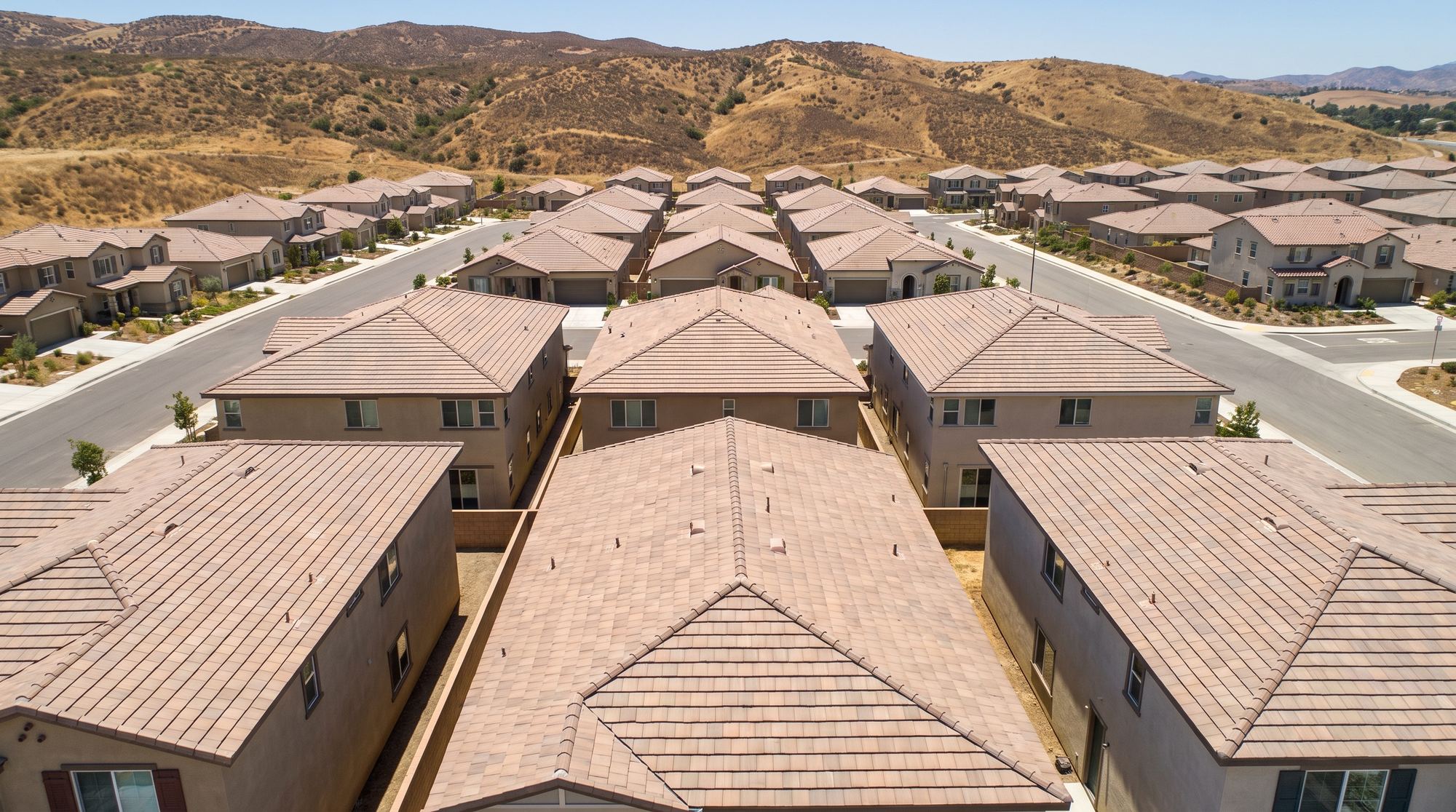 A Santa Clarita tract neighborhood of concrete tile roofs seen from above