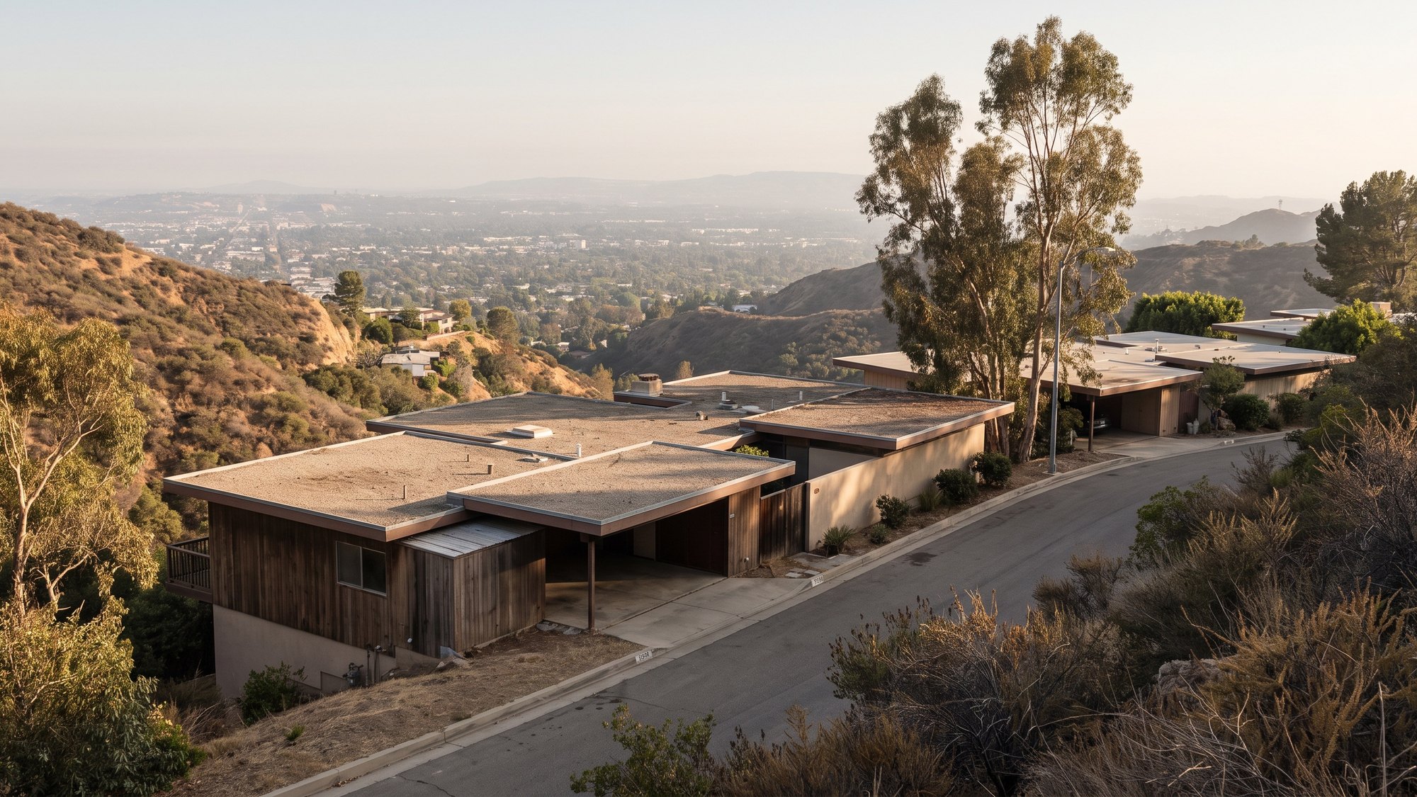 Mid-century roofs stepping down the Studio City hillside below Mulholland